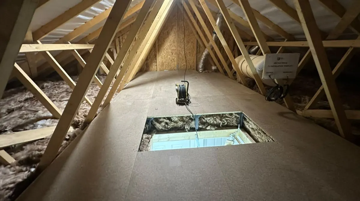 Raised loft boarding on legs above a full depth of loft insulation